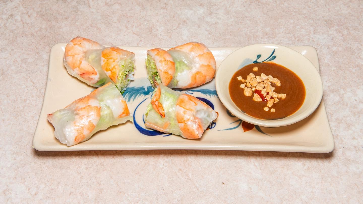 VietFresh's photograph of summer rolls on a rectangular plate beside a dipping bowl.